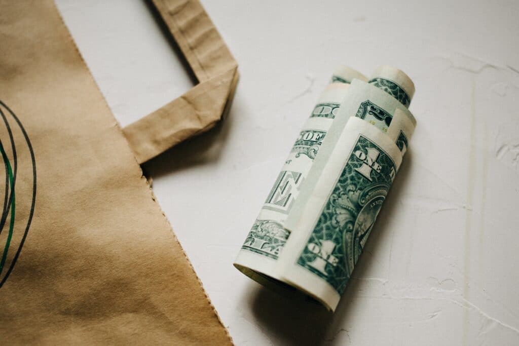 Cash dollars money, with a Kraft package on white background.