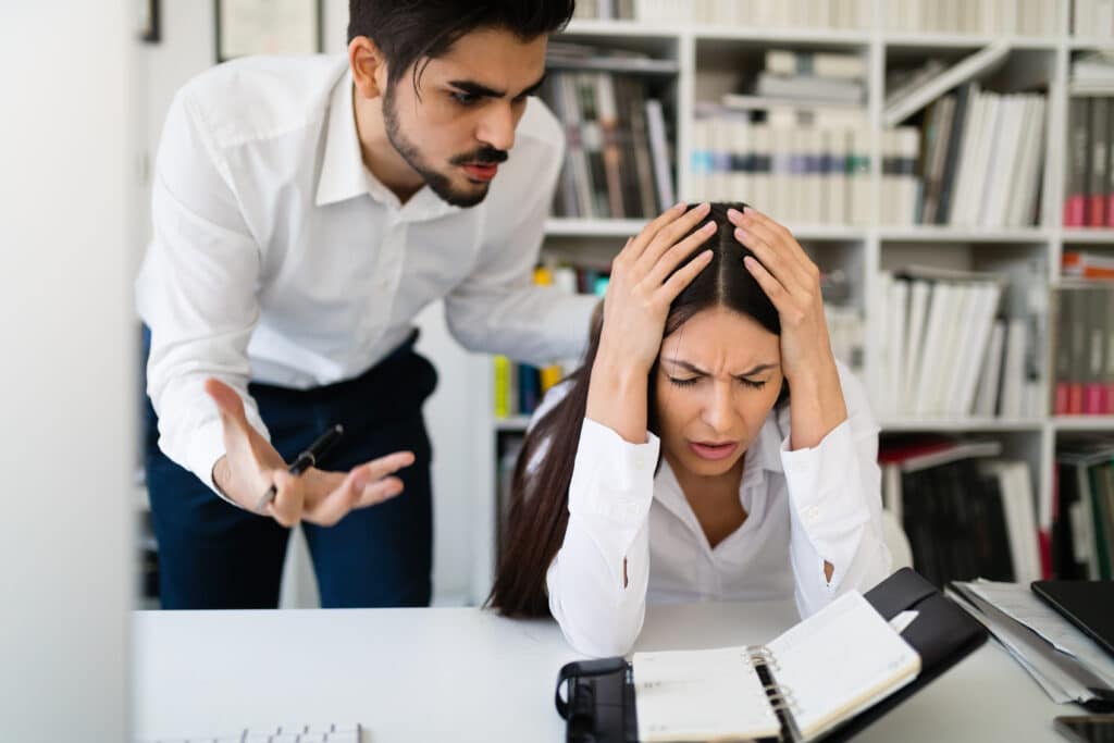 Angry boss yelling at his employee in office for mistakes in work