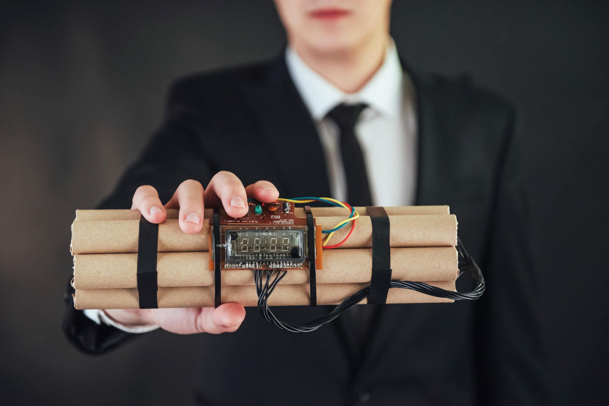 Agency terrorist in a black suit with explosives and detonators.
