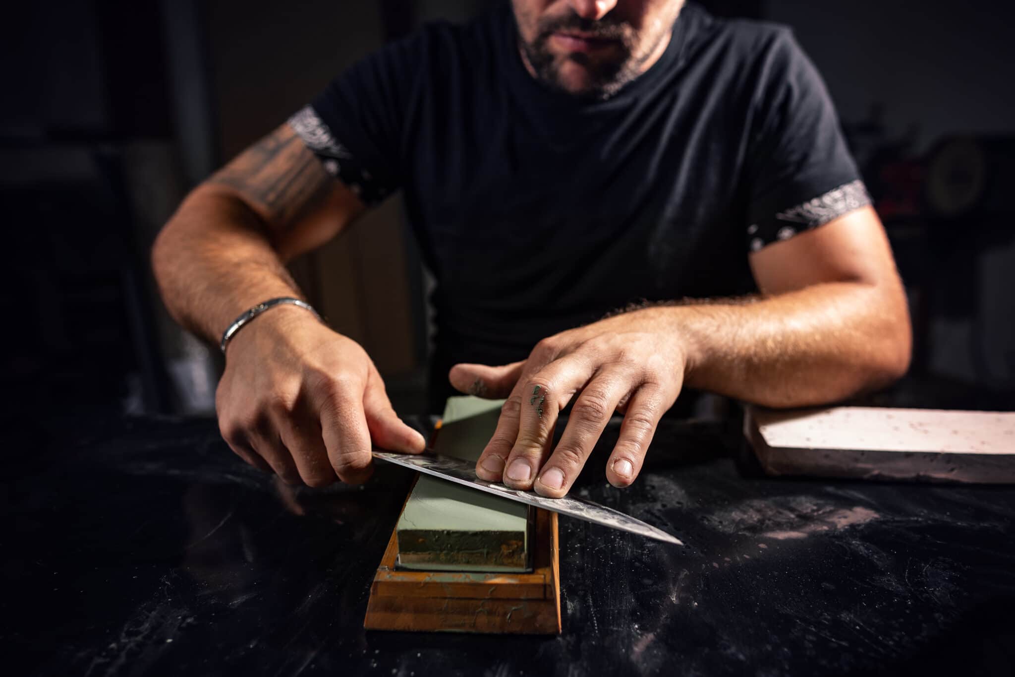 The man using whetstone to sharpening chef knife