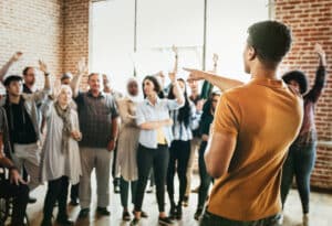 A man presenting to a group, discussing the perfect time for building an audience.